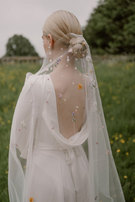 an image of an embroidered wedding veil with delicate colourful flowers Unique Bride Veil, Embroidered Wildflower Veil, Cathedral Veil With Flowers, Embroidered Silk Wedding Dress, Flower Embroidery Wedding Veil, Flowers On Veil, Whimsical Wedding Accessories, Wild Flower Veil Wedding, Untraditional Wedding Veil