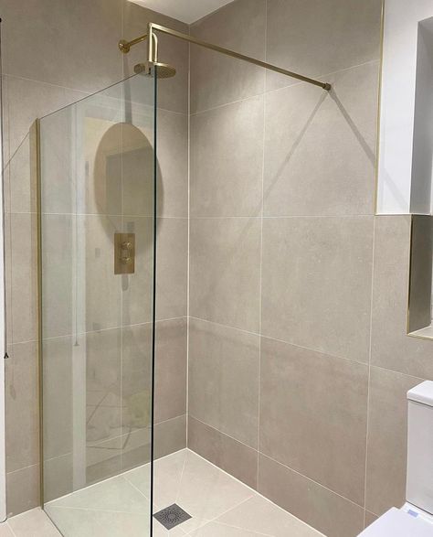 Our Vista Brushed Brass wet room screen glows in this stunning showering space from @athomewithholli 😍 The golden hues of the screen are beautifully coordinated with Hoxton Brushed Brass shower brassware from @brittonbathrooms, set to a relaxing neutral backdrop #brushedbrass #brassbathrooms #goldbathroom #wetroom #modernbathroom #bathroomtransformation #homedecor #homeinteriors #bathroominspiration #goldtaps #renovation #bathroomdesign #bathroominspo #bathroomofinsta #bath #bathroom Neutral Gold Bathroom, Taupe Master Bath, Neutral Shower Tile, Bathroom Taupe, Taupe Bathroom Ideas, Small Beige Bathroom Ideas, Brushed Brass Shower, Taupe Bathroom, Brushed Brass Bathroom