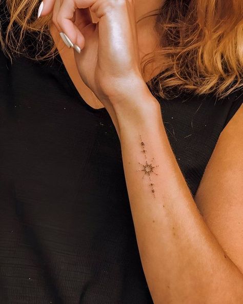 1030 Woman with a small compass and constellations tattoo on her inner forearm, wearing a black sleeveless top. | Sky Rye Design Band Around Leg Tattoo, Tulum Tattoo, Top Of Wrist Tattoos, Side Forearm Tattoo, Side Wrist Tattoos For Women, Tattoo Ideas Female Hand, Minimalist Symbols, Tato Flash, Side Wrist Tattoos