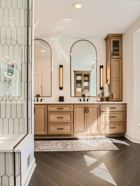 Vanity With Black Tile Floor, Master Bath Ideas Dark Floor, Bathroom Interior Design Black Fixtures, Arched Mirror With Sconces, Bathroom Arch Mirror Ideas, Master Bath Long Vanity, Master Bath With Long Vanity, Bathrooms With Matte Black Fixtures, Custom Double Vanity Bathroom