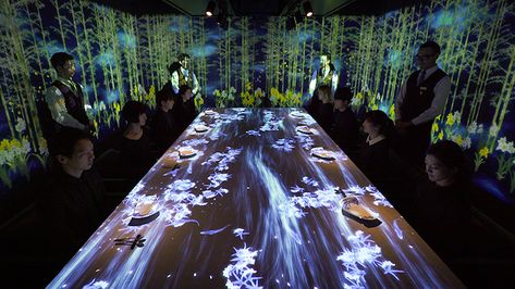 The walls and table fill with teamLab's digital images, created to immerse each diner in a unique world. Titled Worlds Unleashed and then Connecting, the collective explains that “when a dish is placed on the table, the scenic world contained within the dish is unleashed, unfolding onto the table and into the surrounding space. For example, a bird painted on a ceramic dish is released from the dish and can perch on the branch of a tree that has been unleashed from a different dish.” High End Restaurant, Tokyo Restaurant, Asian Art Museum, Dining Design, Restaurant Ideas, Luxury Restaurant, Interactive Installation, Projection Mapping, Modern Restaurant