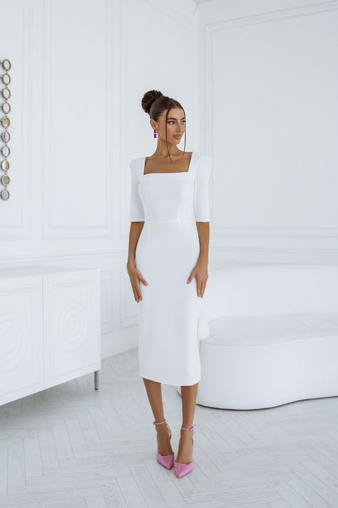 Step into timeless charm with our White Square Neckline Midi Dress. The clean lines and midi length create a versatile and flattering silhouette, ideal for both casual and dressy occasions. #whitedress #mididress #dresses #stylish #eveningdress #partydress #promdress #dresslover #womendress #womenstyle #dressup #fashion White Modest Graduation Dress, Long Sleeve Midi White Dress, Elegant Dresses For Graduation, White Dress Graduation Classy, White Graduation Dress College Classy, Modest Graduation Dress, Elegant White Gown, Graduation Dress College Classy, White Dress Classy