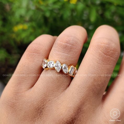 "❤  Welcome To GemioGems  ❤   Multi Shape Brilliant Cut Moissanite Eternity Band, Bezel Set Moissanite Wedding Band, Eternity Diamond Band, Multi Shape Diamond Band ✢ Handmade Item Shop ✢ Diamond: Moissanite / Stimulated / Lab Stone ✢ Material: 14K Solid Gold / 10K Solid Gold / 925 Sterling Silver (Nickle Free) / 950 platinum / 18K Solid gold ✢ Can Be Personalized Item ✢ If you have any questions, share with me anytime. ✢ We gladly accept custom orders too. ✦ Stone Details:   ◈ Shape:  Marquise / Pear / Cushion / Oval / Emerald Diamond ◈ Weight: 4.4 TCW (APPROX)  ◈ Diamond: Moissanite / Stimulated ◈ Color: Colorless ◈ Clarity: VS / VVS1 ◈ Luster: Excellent ◈ Make: High Quality ◈ Mohs Scale : Moissanite 9.25 ◈ Refractive Index : 2.65 (Moissanite) ✦ Ring Details:-   ◈ Metal: 14 K/ 10K Solid Eternity Diamond Band, Like Symbol, Moissanite Wedding Band, Cvd Diamond, Amber Ring, Moissanite Wedding Bands, Eternity Band Diamond, Diamond Band, Eternity Band