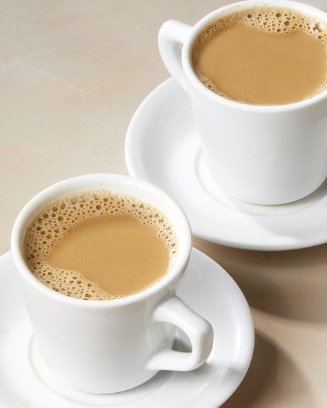 Angled shot of two white tea cups and saucers full of hot milk tea, on a beige surface. 2 Cup Tea, Tea Milk, Hot Milk Tea, Cup Of Tea, Deviled Egg Dip, Orange Pekoe Tea, Leftover Milk, Gluten Free Milk, Milk Tea Recipes