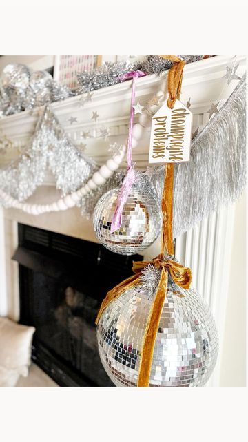 Kelsey Klos on Instagram: "Swap your stockings for disco balls, frame festive wrapping paper, display all the snowy details and add tinsel! 🪩🥂✨" White Disco Ball Aesthetic, Christmas Decor Display Ideas, Disco Ball Holiday Decor, Disco Ball Mantle, Disco Ball Christmas Decorations, Disco Ball Tree Christmas, Disco Ball Christmas Tree Ideas, Disco Christmas Aesthetic, Disco Ball Display