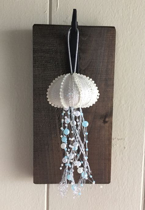 Jellyfish Christmas ornament made from a sea urchin shell. Sea Urchin Jellyfish Ornament Diy, Urchin Shell Crafts, Crafts With Sea Urchin Shells, Jellyfish Christmas Ornaments Diy, Sea Urchin Jellyfish, Jellyfish Ornament Diy, Sea Urchin Decor, Sea Urchin Crafts, Sea Urchin Shell Crafts