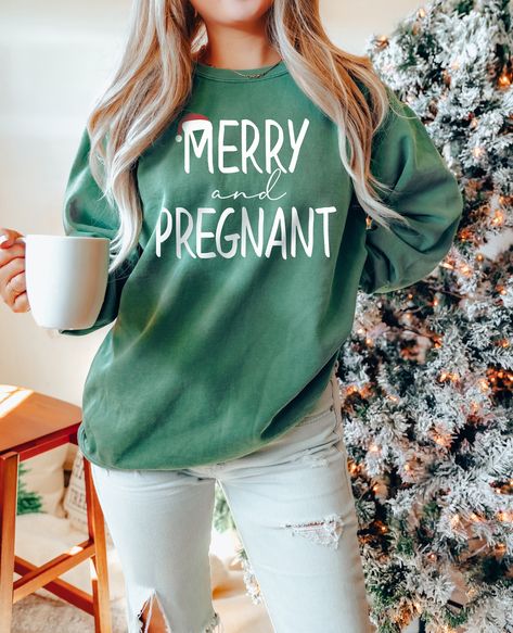 "Merry and Pregnant, Christmas Pregnant, Winter Baby Reveal, Holiday Pregnancy, Xmas Announcement, Comfort Colors®, Santa Sweatshirt WELCOME TO BUTIKCHI  This sweatshirt perfect gift as a holiday apparel. Ideal for any situation, a unisex heavy blend crewneck sweatshirt is pure comfort. How to Order?  Please, choose your favorite color and size from the pop-up window. Select the quantity that you want. Click \"ADD TO CART\". You can go back to add more product color for your loved ones members.  You can complete the checkout process. Please \"Click Proceed to Check Out\" Finally, you have completed all the steps, your product will be prepared to be shipped. Washing Care Instructors Use cold water when washing, do not use bleach, do not dry clean, and do not use an iron directly on the desi Very Merry And Pregnant, Maternity Clothes Winter Casual, Cute Christmas Baby Announcements, Baby Announcing Ideas Christmas, Christmas Baby Announcement To Family, Christmas Pregnancy Shirts, Christmas Pregnancy Outfit, 1st Baby Announcement, Pregnancy Announcement December