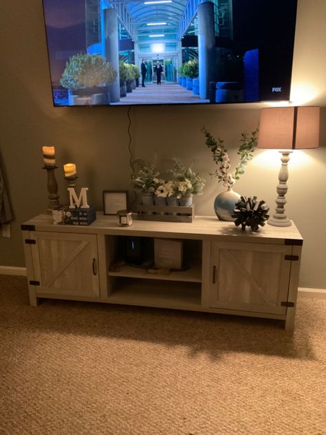 Top Of Tv Stand Decor, How To Decorate Tv Stand With Mounted Tv, Decorating Idea For Tv Stand, Farmhouse Living Room Tv Stand Decor, Tv Stand Decor Under Mounted Tv, Decorate Tv Stand Living Rooms, Tv Stand Decor With Mounted Tv, How To Decorate Under Tv, Decor On Sides Of Tv