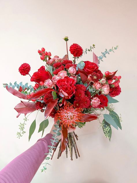 All red blooms with pin cushion protea, spray roses, garden roses, hypericum, chrysanthemums, dahlias, and mixed eucalyptus #bouquet #flowers Red Flowers Bouquet, Pin Cushion Protea, Mixed Eucalyptus, Red Flower Bouquet, Chrysanthemum Bouquet, Dahlia Bouquet, Eucalyptus Bouquet, Red Bouquet, Roses Garden