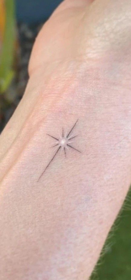 Small Star Burst Tattoo, Star With Name Tattoo, North Star Tattoo White Ink, Memorial Star Tattoos, Twinkling Stars Tattoo, Tiny Firework Tattoo, Northstar Tattoo Design, Small North Star Tattoos, Long Star Tattoo