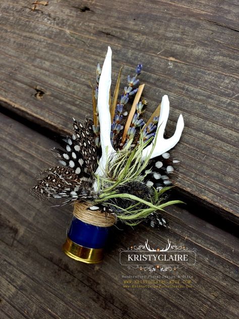 Custom Half Navy Blue Shotgun Shell Boutonnieres with Antlers, Lavender, Guinea Hen Feathers & Thistle 💙
WWW.KRISTYCLAIRE.ETSY.COM 
www.kristyclairefloraldesign.com 
#weddingboutonniere #weddingdecor #wedding #weddingcorsage #weddingparty #weddingdesign #newzealand #shotgun #shotgunshells #antlers #antlerdecor #antlerart #hunting #unique #lavender #thistle #polkadots #guineafowl #newzealandlife #newzealandphotography #thankyou #fauxantlers #mini Fishhook Boutonniere, Shotgun Boutineers, Wedding Decor With Antlers, Western Wedding Boutonniere, Hunting Boutonniere, Shotgun Shell Boutineer, Shotgun Shell Boutonniere Diy, Pheasant Feather Wedding, Antler Themed Wedding