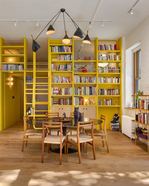 A Yellow Floor-to-Ceiling Library Wall Brightens Up This SoHo Loft - Dwell Table Pendant Lighting, Modern Dining Rooms, Staircase Outdoor, Farmhouse Scandinavian, Soho Loft, Plant Kitchen, Light Hardwood, Light Hardwood Floors, Library Room