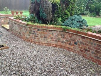 Garden Brick Wall, Backyard Walls, Brick Retaining Wall, Maria Burton, Courtyard Oasis, Retaining Wall Bricks, Brick Inspiration, Brick Wall Gardens, Wood Retaining Wall