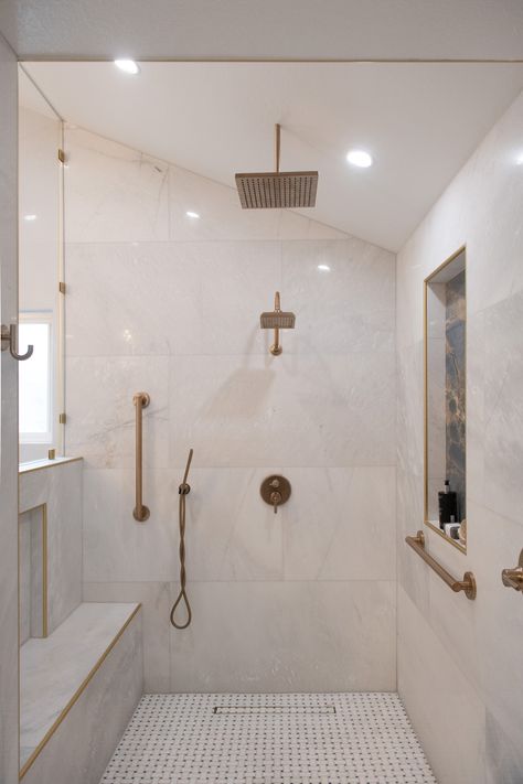 Transform your shower into a luxurious retreat with this stunning Calacatta Gold marble tile on the walls, paired beautifully with basketweave marble mosaic flooring. The warm brass fixtures perfectly complement the timeless elegance of the marble, making this space both sophisticated and serene. Let us help you transform your space. #BathroomInspiration #MarbleTile #CalacattaGold #LuxuryBathroom"​ Calacatta Oro Marble, Marble Shower Tile, Calacatta Gold Marble, Marble Showers, Classic Tile, Calacatta Gold, Brass Fixtures, Marble Tile, Marble Bathroom