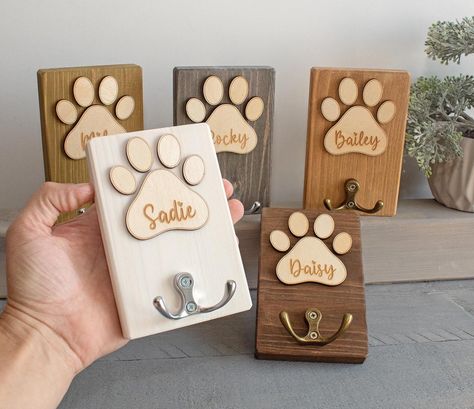 Wooden Dog Leash Storage. Wood Sign - The base is a pine board. - Personalized with your dog name. - Sign and Letters is handmade from wood and has been painted in our studio. - A great gifts for dog owners. - Attached 1 hanger. Dog sign size: (HxW) 5,5" x 3,5" (14 x 9cm). Available colors: white + black font light brown + white font brown + white font light gray + white font olive + white font ebony + white font Diy Gifts For Dog Lovers, Wood Dog Projects, Dog Leash Station, Wooden Dog Projects, Laser Dog Ideas, Wood Dog Leash Holder Diy, Laser Engraved Dog Gifts, Dog Name Signs Wooden, Personalized Wood Gifts