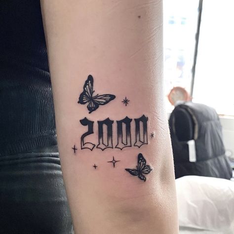 Birth Year Tattoo With Butterfly, Butterfly With Year Tattoos, Birth Year Tattoo Ideas Ankle With Butterfly, 2005 Butterfly Tattoo, Year Tattoo Number With Butterfly, Butterfly And Year Tattoo, 2000 Knee Tattoo, 1998 Tattoo Above Knee, 2000 Tattoo Ideas Women