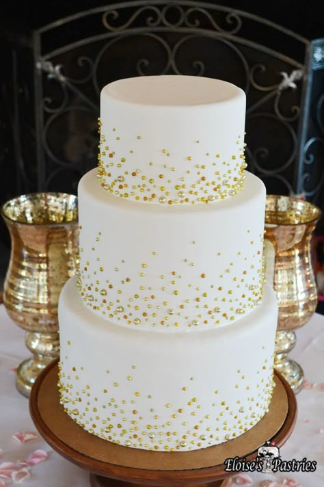 This simple wedding cake becomes the star of the show with the addition of subtle gold beads on each tier. Cakes with understated but elegant decor are perfect for weddings in any season. #EloisesPastries #bakery #weddingcake #weddings #cake #gold #weddingseason Gold Anniversary Cake, Golden Wedding Cake, Golden Wedding Anniversary Cake, 50th Wedding Anniversary Decorations, 50th Wedding Anniversary Cakes, 50th Anniversary Cakes, Spring Wedding Cake, 50th Wedding Anniversary Party, Wedding Anniversary Decorations