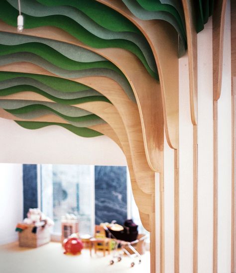 the monumental interior element is made of plywood boards, with leaves composed of suspended, cut paper sheets. Kindergarten Architecture, Paris Nursery, Kindergarten Interior, Tree Interior, Daycare Design, Kindergarten Design, School Interior, Library Design, Kids Interior