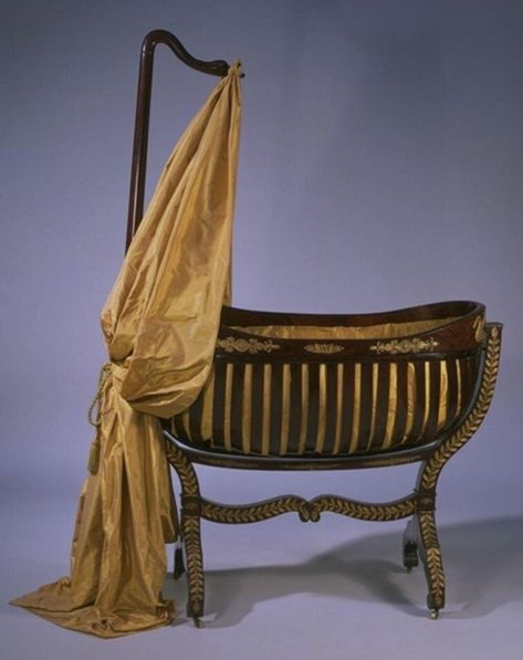 ‘Bateau’, or boat-shaped, cradles of this type are characteristically French, but the decoration is not: they were usually of plain mahogany. What seems most likely is that the cradle was made in France, certainly to a French design, and the ormolu decoration - gilt brass or bronze metalwork, from the French or moulu, ground gold - was applied in Germany. Baby Cradles, Cradle Decoration, Rocking Cradle, Wooden Cradle, Museum Of Childhood, Regency Furniture, Interesting Interiors, Victorian Interiors, Baby Cradle