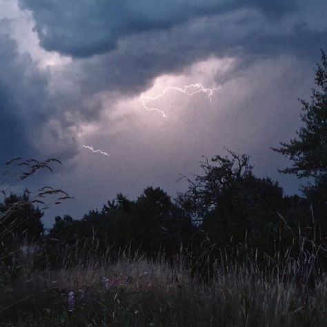 Lightning in blue storm clouds over a long grass field. Nature, Tumblr, Lightning Aesthetic, Pink Lightning, Rain And Thunderstorms, Album Aesthetic, Blue Lightning, Summer Storm, Phoebe Bridgers