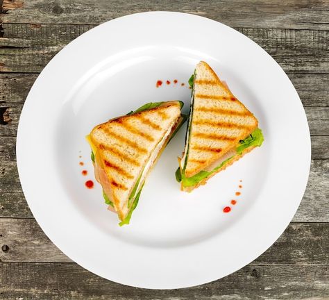 Sliced sandwich on white plate, top view... | Premium Photo Plating Ideas For Sandwiches, Plating Sandwich, Sandwich Plating Ideas, Food Top View, Paneer Sandwich, Big Sandwich, Food Photography Lighting, Plate Of Food, Ice Cream Menu