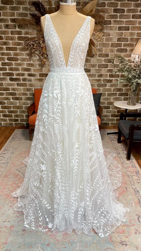 Boho lace a-line wedding dress with plunging neckline, open back, and long train #lifeisbettergilded #gildedbridal #getgilded Floral Sparkly Wedding Dress, A Line Deep V Wedding Dress, Leaf Lace Wedding Dress, Low Cut Wedding Dress, V Neck Lace Wedding Dress, Earthy Wedding Dresses, Rish Bridal, Lace Overskirt, Plunging Neckline Wedding Dress