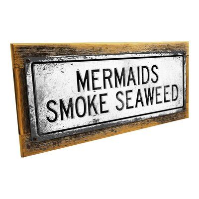 Our Retro Mermaids Smoke Seaweed metal sign is affordable art for your tropical decors, surf shack, beach cottage, vacation rental, or tiki bar. This white wall plaque has black accents and was designed in the industrial style. The metal sign is made from 24-gauge steel, and is mounted on a sturdy, hand-made frame with weathered screws to complete the rustic look. | Trinx Framed, Outdoor Retro Mermaids Smoke Seaweed Metal Sign, Wall Art For Tropical Decor, Surf Decor, Beach Cottage, Vacation Ren Surf Cottage Decor, Rustic Surf Decor, Boho Tiki Decor, Mid Century Tiki Decor, Tiki Signs Diy, Rustic Beach Bathroom Ideas, Moody Beach Decor, Gothic Beach Decor, Southern Room Decor Country Bedrooms