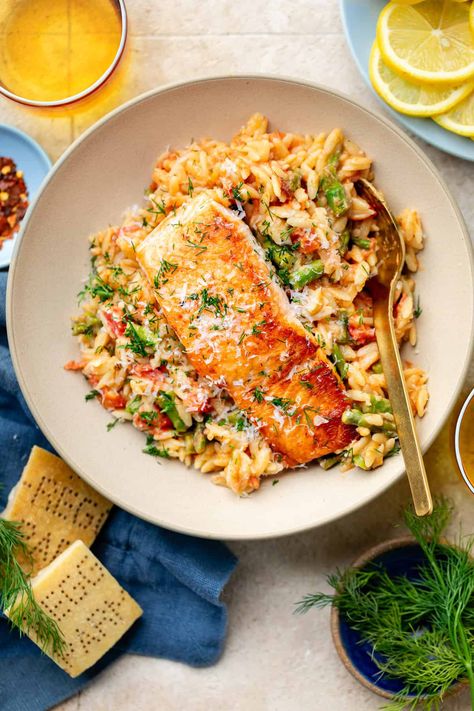 Switch up your standard salmon routine and try out this delicious Creamy Salmon Orzo Skillet! Between the veggies, parmesan cheese, and lemon, it's overflowing with savory flavors. Creamy Salmon Orzo, Salmon With Orzo Recipes, Salmon And Prawn Recipes, Orzo Salmon Recipes, Lemon Orzo Salmon, Salmon And Orzo Recipe, Orzo Salmon, Salmon With Orzo, Salmon Orzo Recipe