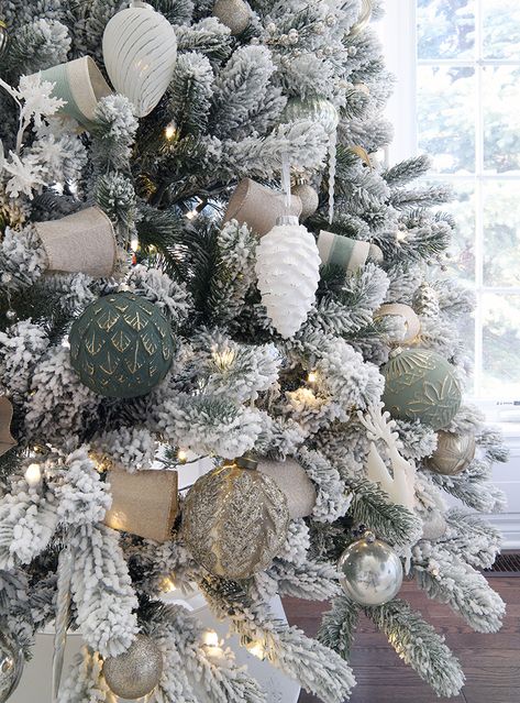 Rustic Green Christmas Tree, Gray White Green Christmas Decor, Sage Color Christmas Decor, White And Dark Green Christmas Tree, Green Ornaments On Flocked Tree, White Silver And Green Christmas Decor, Green Brown And White Christmas Tree, Green White Natural Christmas, Flocked Tree Green Ornaments