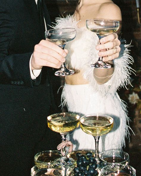 Champagne tower, vintage wedding, vintage wedding inspiration, coupe glasses, bows, bows on glasses, feather wedding dress, feather dress, champagne tower with fruit, champagne tower with grapes, anti bride, vintage wedding aesthetic, old hollywood aesthetic, hollywood wedding aesthetic Luxe Vintage Aesthetic, Old Holly Wood Aesthetic, Wedding Catering Aesthetic, Glitz And Glam Holiday Party, 1920s Glamour Aesthetic, Old Hollywood Mood Board, Romcom Wedding Aesthetic, Couple Champagne Photo, 1950s Wedding Aesthetic