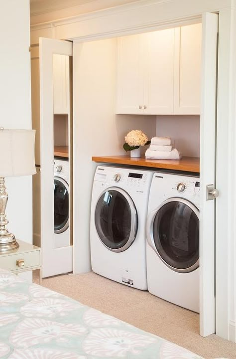 Master bedroom features a washer and dryer in closet with pocket interior mirror doors. Closet Washer And Dryer Ideas, Washer And Dryer Ideas, Washer Dryer Closet, Transitional Laundry Room, Laundry Doors, Closet Redo, Retractable Door, Basement Laundry Room, Basement Laundry