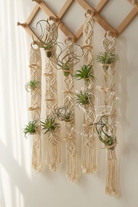 Attach a wire grid panel to the wall and use S-hooks to hang plants in various arrangements. Macrame Orchid Hanger, Macrame Plant Decor, Air Plant Macrame Hanger Diy, Macrame Kitchen, Install Floating Shelves, Macrame Air Plant Hanger, Indoor Plant Hangers, Boho Macrame Wall Hanging, Macrame Plant Hanger Patterns