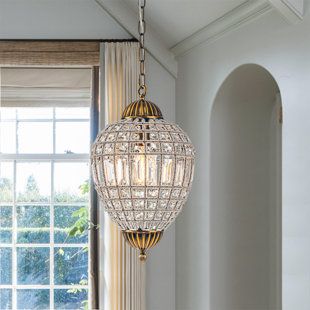 This globe crystal chandelier is a stylish blend of function with classic and vintage appeal. Crafted with a metal frame and high-quality crystal, the metal frame is wrapped handmade with crystal wire to give this fixture a special and texture look, and create a warm ambiance. Available in 3 sizes, the diameters are 12, 20, and 24 inches. Hung by a 59" adjustable chain and mounted by a sloped ceiling-compatible canopy, this classic pendant chandelier definitely fits any place in your house. Size Round Crystal Chandelier, Crystal Globe, Tiered Chandelier, Simple Lamp, Creative Interior, Unique Styling, Unique Chandeliers, Style Français, Geometric Chandelier