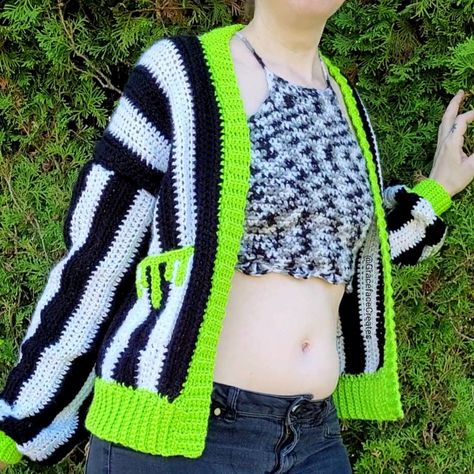 A black and white striped crochet cardigan with neon green trim & slime drips pockets Easy Goth Crochet, Crochet Drip Pattern, Crochet Cardigan Halloween, Spooky Crochet Cardigan, Free Crochet Patterns Wearables, Crochet Pattern Jumper, Halloween Crochet Patterns Free Clothes, Beetlejuice Knitting, Crochet Beetlejuice Cardigan