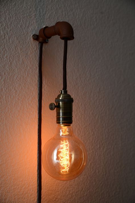 Steampunk Wall Pendant Lamp - Wall Lamps & Sconces - STEAMPUNK WALL PENDANT LAMP For a nice retro look is the lamp uses an Edison light bulbs (40watts/E27er version) supplied. The lamp has a 3 m-long, black textile cable, a high-quality metal frame with rotary switch and a plug for European Sockets. You can determine the color of the cable and... #Concept #Diy #Edison #Industrial #Lightbulb #Metal #Recycled #Sconce #Simple #Steampunk Wall Lamps Diy, Diy Industrial Lighting, Wall Pendant, Steampunk Wall, Diy Light Fixtures, Edison Light, Bedroom Light Fixtures, Edison Bulbs, Edison Lighting