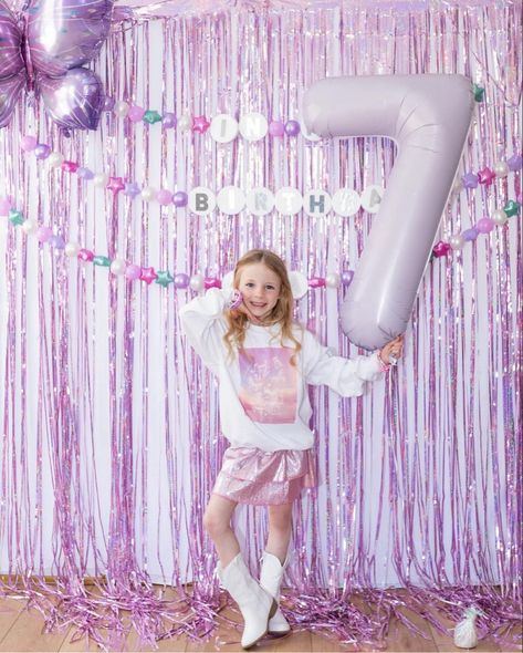 Taylor Swift birthday party for a 7 year old girl. Backdrop with friendship bracelet garland that says In my Birthday Era. Taylor Swift Birthday Party Outfit, Taylor Swift Birthday Pictures, Different Taylor Swift Eras, Taylor Swift Enchanted Birthday Party, Taylor Swift Birthday Party Outfit Ideas, Taylor Swift Birthday Photoshoot Ideas, Taylor Swift Birthday Outfit Kids, Eras Tour Backdrop, Taylor Swift Backdrop Party