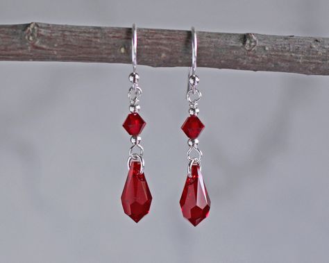 "Red crystal teardrop earrings are made with siam crystal teardrops accented with silver or gold beads. They dangle 3/4\" from sterling silver or gold fill ear wires. ❖ Crystal Passions crystals ❖ silver or gold fill beads ❖ .925 sterling silver or 14k gold fill ear wires Earrings shown are on french hook ear wires. All earring types are sterling silver or gold fill with the exception of clip-ons, which are silver or gold plated." Red Teardrop Earrings, Red Crystal Earrings, Red Earrings Aesthetic, Red Drop Earrings, Vintage Red Earrings, Red Earrings Dangle, Vampire Jewelry, Gem Drawing, Red Jewel