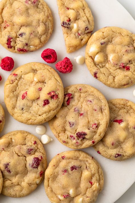 Flavorful and perfectly chewy, these White Chocolate Raspberry Cookies are perfect for weekend baking. They can be ready in 30 minutes with no chilling required! Cookies Raspberry White Chocolate, White Raspberry Cookies, Gooey Raspberry White Chocolate Cookies, Cookies With Raspberries, Baking White Chocolate, White Choc Raspberry Cookies, Raspberry White Chocolate Cookie, White Chocolate Chip Raspberry Cookies, Easy To Bake Cookies