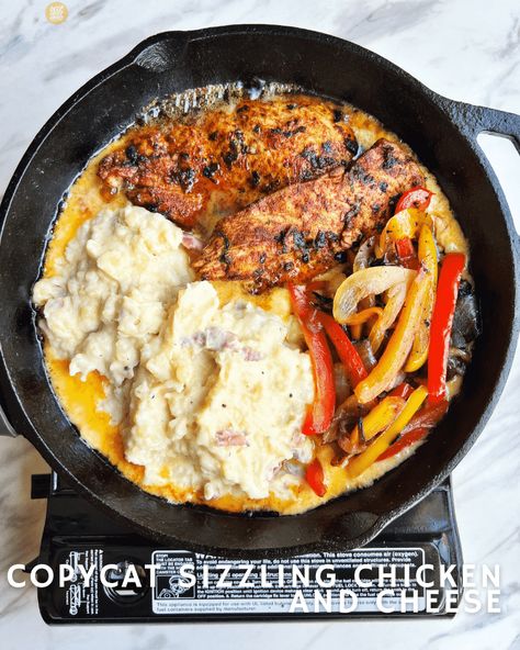 This Copycat Sizzling Chicken and Cheese - my rendition of the infamous TGI Fridays dish - is pretty easy to make, but it does require some multi-tasking Sizzling Chicken And Cheese, October Dinner, Sizzling Chicken, Chicken And Cheese Recipes, Chicken And Cheese, Tgi Fridays, Grilled Peppers, Garlic Puree, Garlic Mashed Potatoes