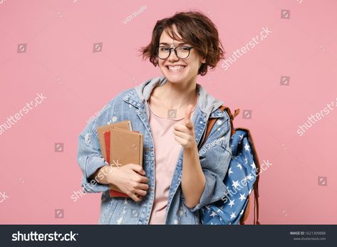 Smiling woman student in denim clothes glasses backpack isolated on pastel pink background. Education in school university college concept. Mock up copy space. Hold books point index finger on camera #Ad , #sponsored, #pastel#isolated#backpack#Education Pastel, Background Education, Pastel Pink Background, Denim Clothes, It's A Secret, University College, Pastel Background, Body Reference, Bank Card