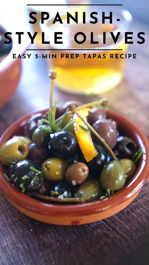 Marinated olives Spanish style is a classic tapas that’s served all over the country. From dusty roadside bars to the most decadent restaurants in the capital of Madrid. Spanish olives adorn every table and are a staple tapas. The good news is that marinated olives are very easy to make at home. With only 5 minutes of prep time and a handful of easy-to-find ingredients, you can make Spanish-style marinated olives for your next dinner party or tapas night. #tapas #olives #marinatedolives Spanish Olives Recipes, Tapas Style Food, Spanish Tapas Dinner Party, Paella Sides, Spanish Appetizers Tapas Party, Spanish Marinated Olives, Tapas Vegetables, Spanish Dinner Party, Tapas Dinner Party