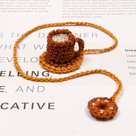 If you're searching for a unique and charming gift for a book enthusiast or a bookmark that can add some joy to your reading, then you need not look any further than this Cup of Coffee bookmark. It showcases a delightful cottagecore design that is sure to bring pleasure. Every bookmark is crafted by hand with high-quality cotton yarn and stuffed with durable and soft polyester fiber. With a length of about 30 cm or 11.8 inches, the string and tassel are suitable for most books, and because of th Book Lover Crafts, Coffee Crochet, Crochet Coffee, Crochet Coffee Bookmark, Crochet Cute Bookmark, Teabag Crochet Bookmark, Crochet Thread Book Markers, Crochet Bookworm Bookmark Free Pattern, Reading Accessories