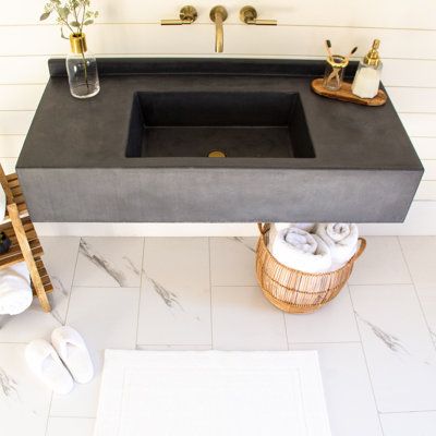 A wall-hanging bathroom vanity with metal bracing and 9'', 100% glass fiber reinforced concrete top. The integrated sink and two-part sealer make for easy clean-up and lifelong durability. Also includes integrated 2'' backsplash. Our box style sink fits any standard drain and a plumbing nut is attached to the underside for easy plumbing hook-up. Brackets are included and mount to wall studs; hardware for mounting is included and any construction adhesive will firmly attach concrete top to bracke Concrete Shower Pan, Vanity With Backsplash, Concrete Shower, Concrete Vanity, Powder Room Sink, Floating Sink, Wall Mount Sink, Concrete Bathroom, Integrated Sink