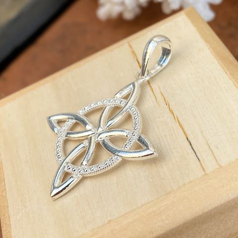 Sterling silver Irish/Scottish celtic trinity knot charm pendant. The Trinity Knot has a beautiful form with three interlinked leaf-like shapes which give an overall triangular profile. From these relatively simple shapes a seemingly complex trefoil knot is formed, a knot which cannot be untied. Although there are many interpretations of the trinity knot, ancient Christianity believes the three points represent the three elements of the holy trinity: Father, Son, + Holy Spirit. Measures: 1 1/8" Celtic Wedding Band Set, Eternity Knot, Scottish Celtic, Bead Embroidered Bracelet, Celtic Wedding Bands, Embroidered Bracelet, Saint Jewelry, Heaven Quotes, Celtic Trinity Knot