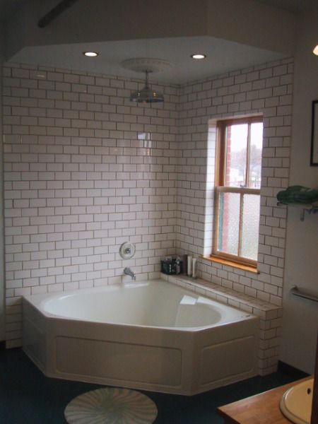 Tile surround, the wall and shelf, maybe wood board around the tub. Bath Tub Shower Combo, Corner Tub Shower Combo, Corner Bathtub Shower, Corner Tub Shower, Corner Jetted Tub, Bathtub Shower Combo, Open Showers, Small Tub, Bathtub Remodel