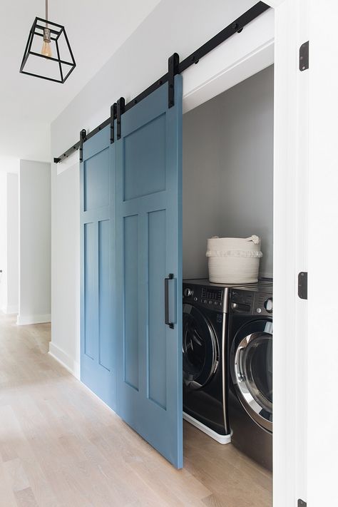 Isn’t this blue barn door gorgeous? I love the craftsman style paneling too. | house build:  M House Development Silver Closet, Laundry Bathroom Combo, Laundry Closet Makeover, Hallway Laundry, White Hallway, Small Laundry Room Makeover, Tiny Laundry Rooms, Hallway Closet, Laundry Room Closet