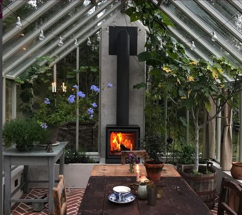 a fireplace in a sunroom feels very homey... Greenhouse Shed, Home Greenhouse, Casa Container, Diy Greenhouse, Greenhouse Gardening, Table Chairs, Pergola Plans, Garden Office, Glass House