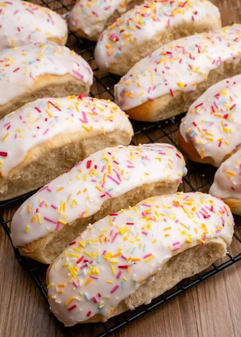 Craving something sweet and homemade? Look no further! Our homemade iced buns are the perfect blend of fluffy, sweet, and oh-so-satisfying. Perfect for tea time, a special treat, or just because you deserve it. With a golden crust and a soft inside, topped with a glaze of sweet icing and sugar strand sprinkles. #IcedBuns Chocolate Fairy Cakes, Finger Rolls, Iced Buns, Rock Cake, British Recipes, Fairy Cakes, British Baking, Bun Recipe, No Sugar Foods