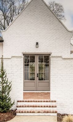 White Brick Entryway Exterior, Cream Exterior Brick, Creamy Brick Exterior, Cap Cod Exterior Paint Colors, White House Taupe Garage Doors, Almond Color Windows Exterior, White And Taupe House Exterior, Addition On Brick House, White French Country House Exterior