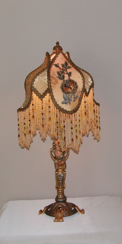 Here is a  classic Antique Victorian Cast Iron Lamp depicting fruit and nuts. It is pared with a "Tulip" shade rich with unique detail.  First it is lined and then covered in ombre dyed Silk Charmeuse.  Alternate panels are topped with;  Antique Hand Made Metal Lace embellished with crystals, and Vintage Metallic Net overlaid with wonderful 1920's Silk & Metal Appliques. The insert panels are covered in Antique French Silk Brocade. Vintage Metal Trim and Hand Beaded Glass Fringe repeat the warm Victorian Artifacts, Weird Lamps, Victorian Lamps, Victorian Bedroom, Victorian Lampshades, Decor Lamp, Victorian Furniture, French Silk, Iron Lamp